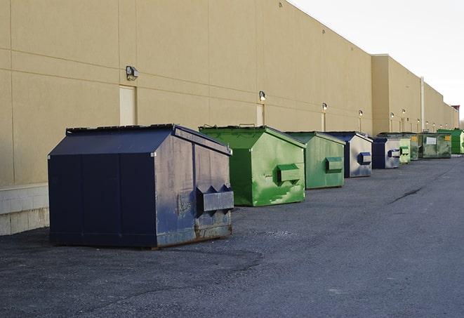 bright yellow construction dumpster full of discarded materials in Buena